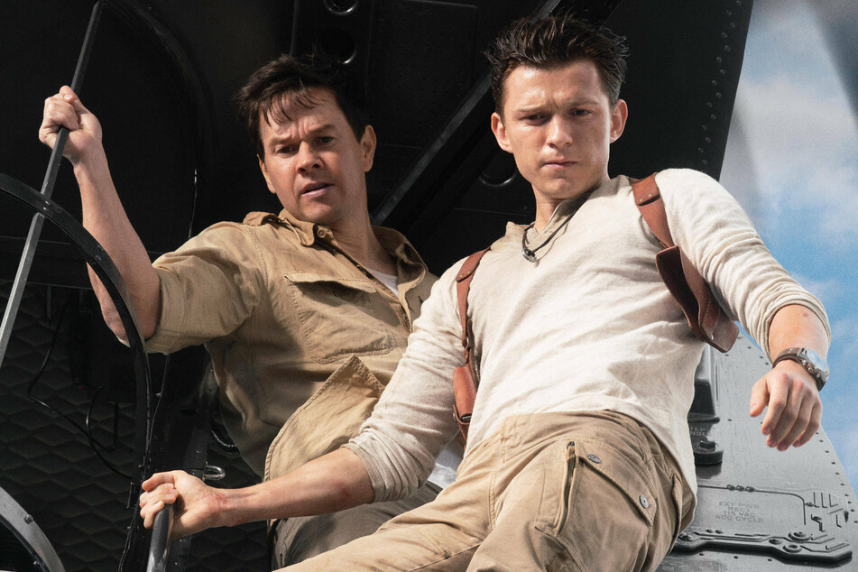 Tom Holland and Mark Wahlberg portray Nathan Drake and Victor "Sully" Sullivan, respectively, in the action-adventure film Uncharted.