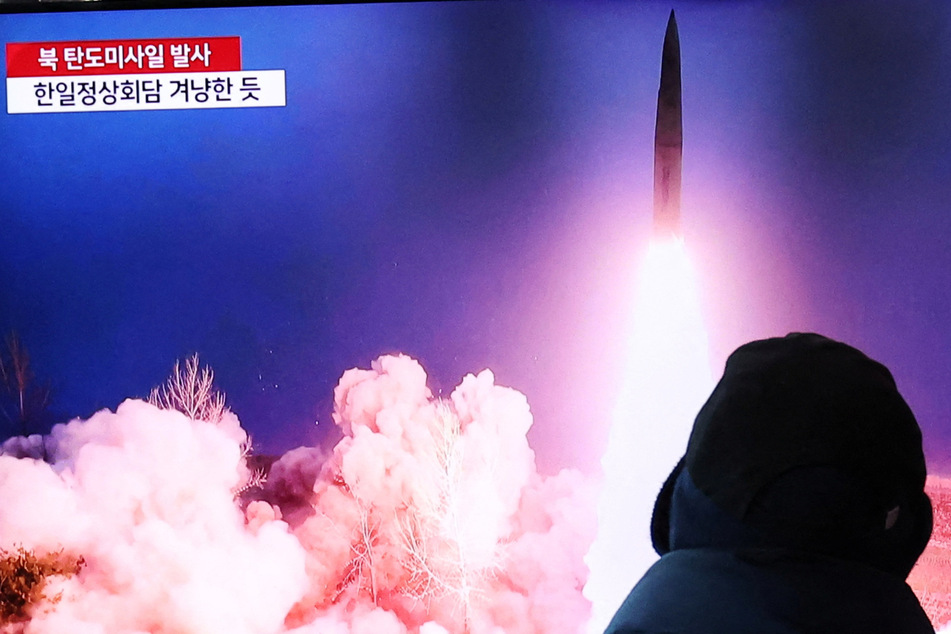 People in South Korea watch a TV report with file footage of North Korea firing a ballistic missile into the sea off its east coast.