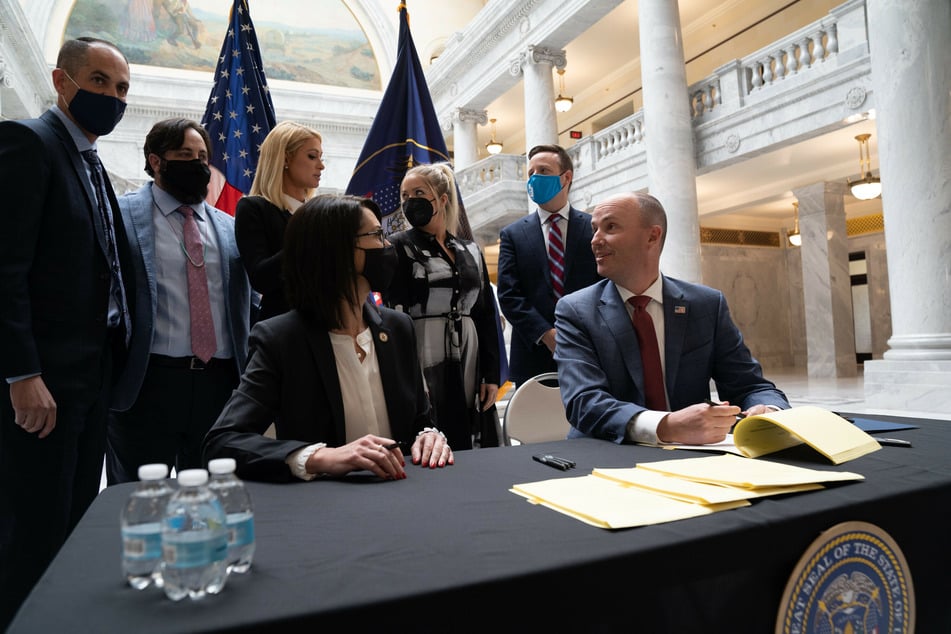 Utah Governor Spencer Cox signed the bill into law on Tuesday, as Paris Hilton watched on.