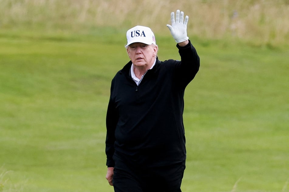 President Donald Trump waves on the golf course at Trump Turnberry resort in Scotland on July 26, 2025.