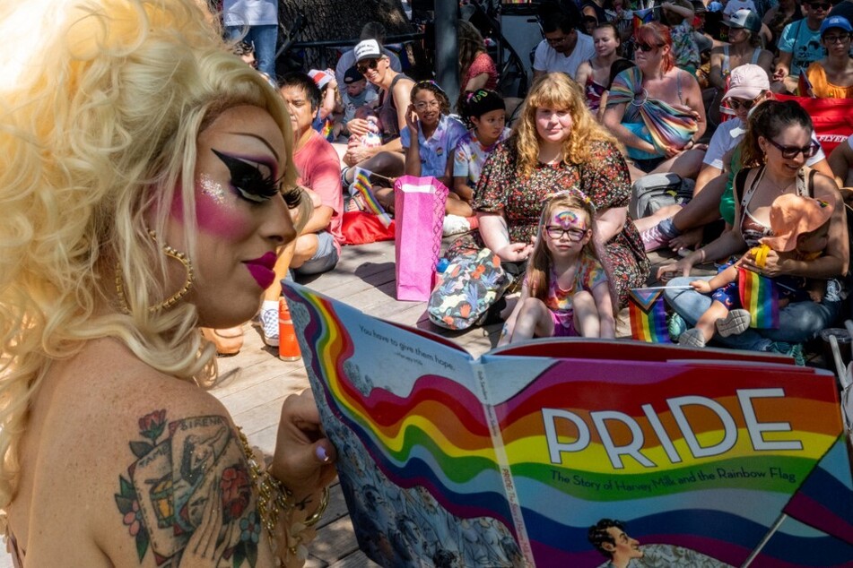 Brigitte Bandit, who sued over Texas' drag ban, reads a book during a drag time story hour in June 2023 in Austin.