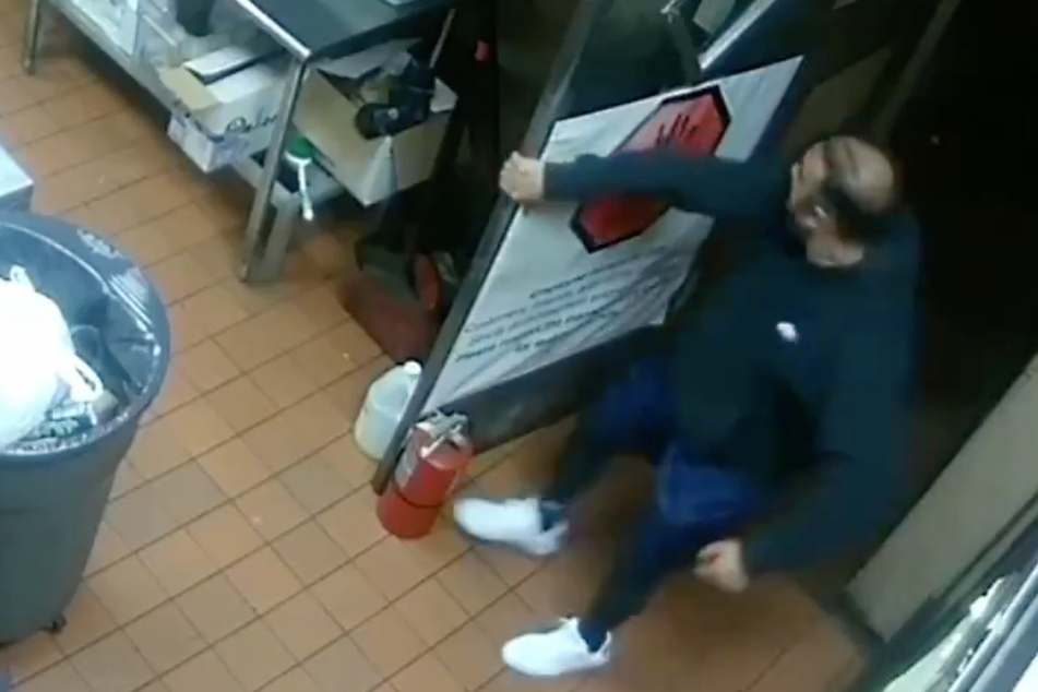 Security cameras show Asif Raja using a flammable liquid to set multiple fires in his restaurant.