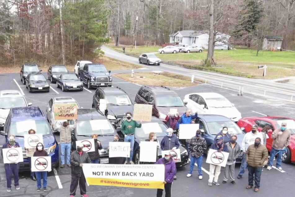 Members and supporters of the Brown Grove community protest against the planned construction of a Wegmans distribution center in their neighborhood.