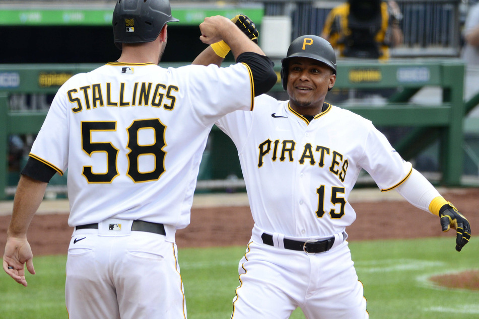 Pirates shortstop Wilmer Difo (15) and catcher Jacob Stallings (58)
