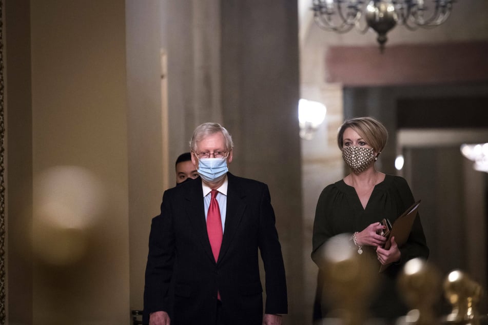 Senate Majority Leader Mitch McConnell walks to the Senate Chamber for a vote on December 21.