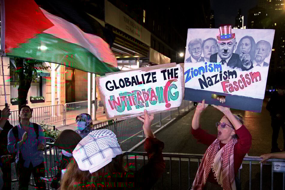 Pro-Palestinian activists hold flags and signs during the "Autonomous Noise Demonstration for Gaza" outside the hotel of Israel's Prime Minister Benjamin Netanyahu in New York City on September 25, 2025.