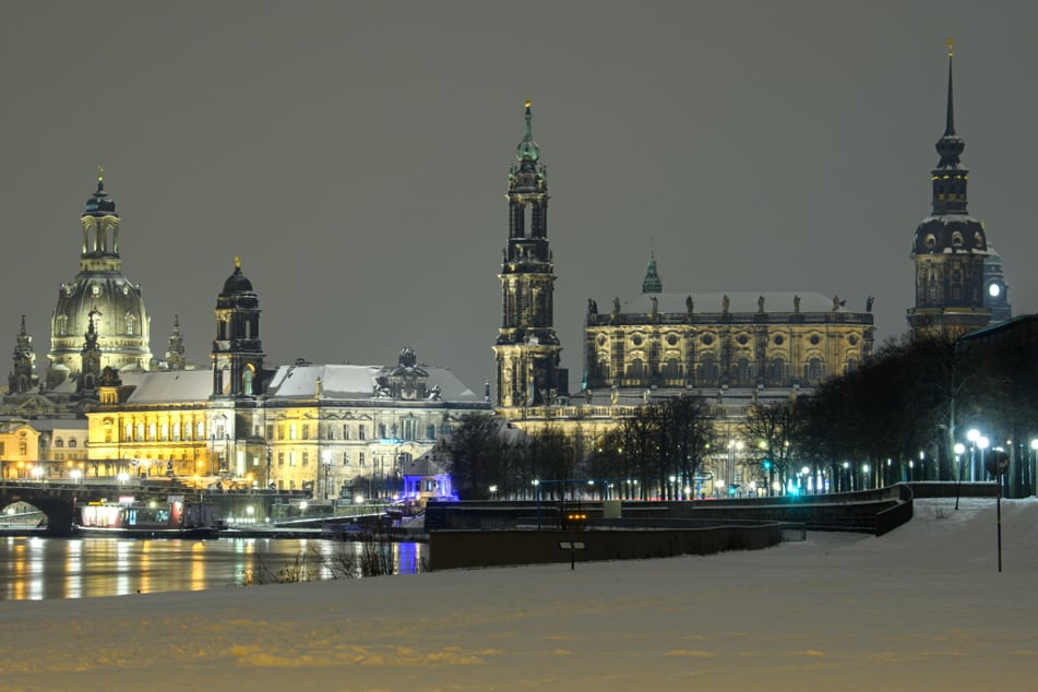 Dresden: Blick am Abend über das verschneite Elbufer vor der Altstadt mit der Frauenkirche, dem Ständehaus, der Hofkirche, dem Hausmannsturm und dem Rathaus.