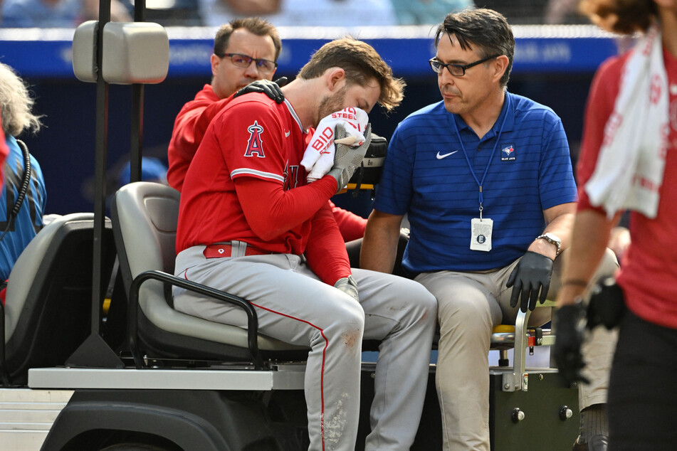 Los Angeles Angels left fielder Taylor Ward is taken off the field on a cart after being struck on the head by a pitch.