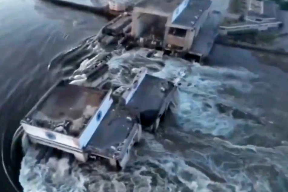 Dieses vom ukrainischen Präsidialamt über AP veröffentlichte Videostandbild zeigt Wasser, das durch einen Durchbruch im Kachowka-Staudamm fließt.