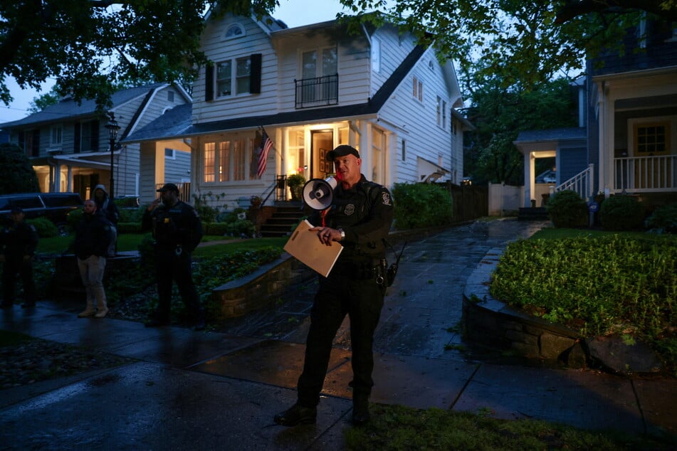 A police officer in front of Brett Kavanaugh's home in Maryland.