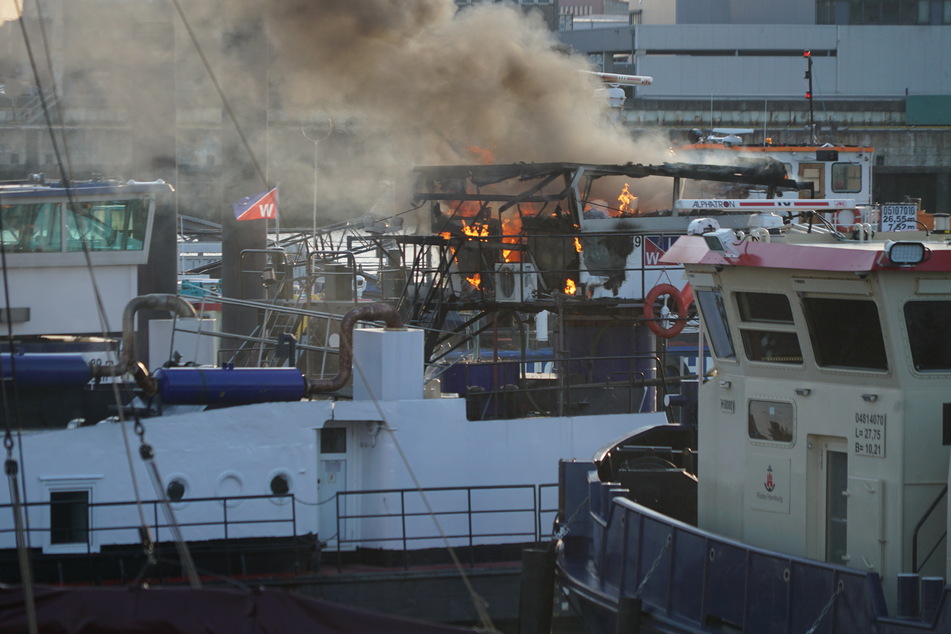 Hamburg: Schiff am Hamburger Hafen in Flammen: Löschboot im Einsatz
