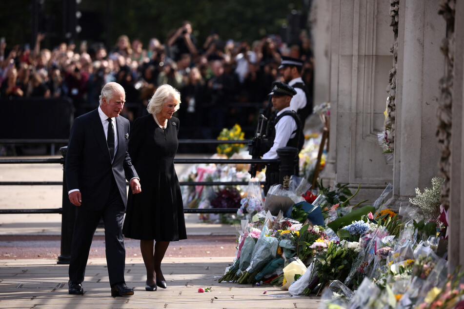 King Charles III and Queen Consort Camilla arrive at Buckingham Palace on Friday.