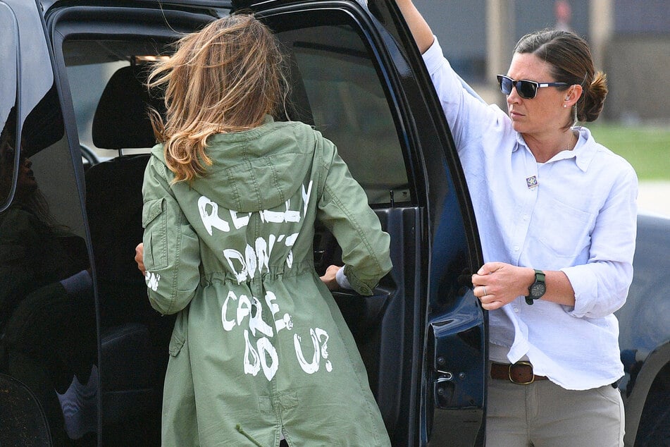 First Lady Melania Trump (l) departs Andrews Air Force Base wearing a jacket emblazoned with the words "I really don't care, do you?" following her surprise visit with child migrants on the US-Mexico border on June 21, 2018.
