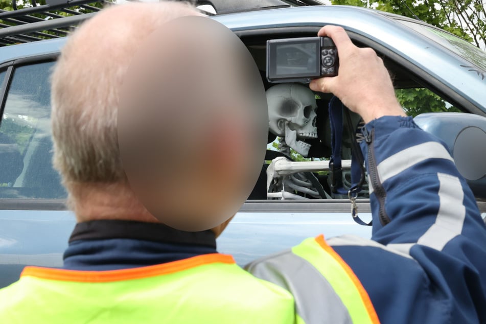 Verrückt! In einem Auto, das sich auf einem Anhänger befand, saßen zwei unechte Skelette auf den Sitzen. Die Beamten schossen direkt Fotos.