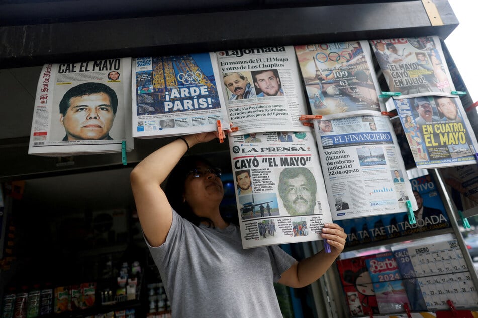 Newspapers reporting the El Paso, Texas, arrest of Mexican drug lord Ismael "El Mayo" Zambada and Joaquin Guzman Lopez are on display in Mexico City.