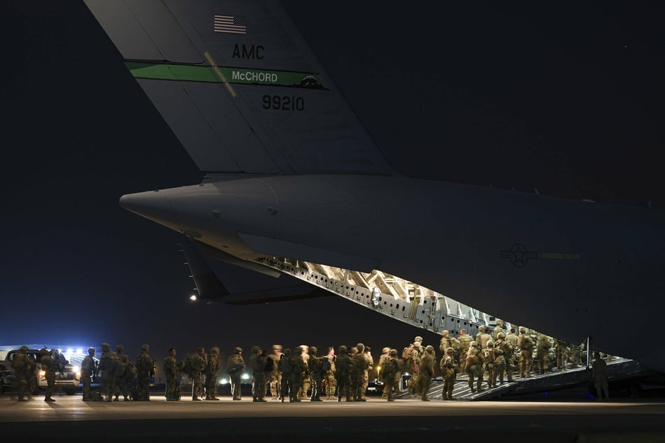 Soldiers board a C-17 Globemaster III aircraft prior to departure for Hamid Karzai International Airport, Afghanistan.