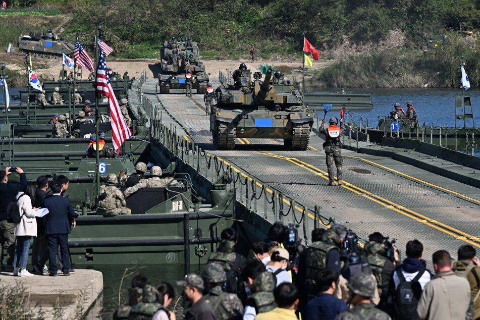 South Korea's K2 tanks cross a river over a floating bridge during a South Korea-US joint river-crossing drill as part of the annual Hoguk military exercise in Yeoju on October 19, 2022.