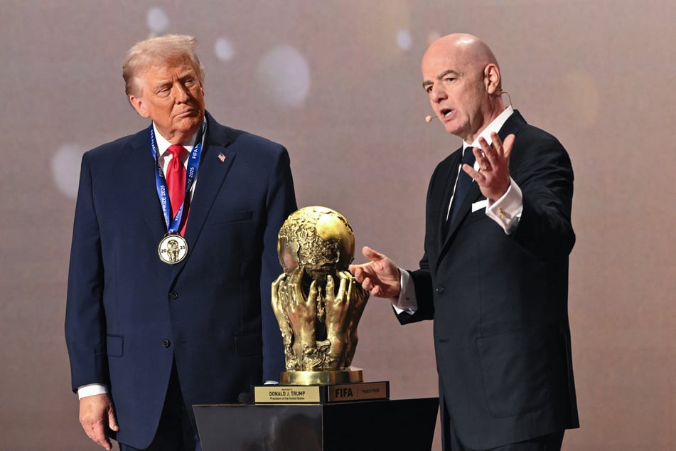 President Donald Trump (l.) receives the FIFA Peace Prize from FIFA President Gianni Infantino (r.) during the draw for the 2026 World Cup at the Kennedy Center in Washington DC on December 5, 2025.