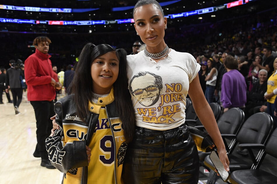 Kim Kardashian's daughter North West (l.) is almost taller than the reality star, per new snaps from her son's basketball game.