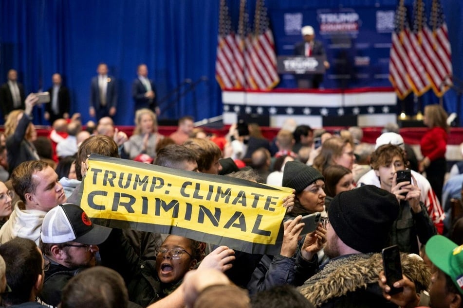 Climate protesters disrupt 2024 Republican presidential hopeful Donald Trump as he speaks at a rally in Indianola, Iowa.