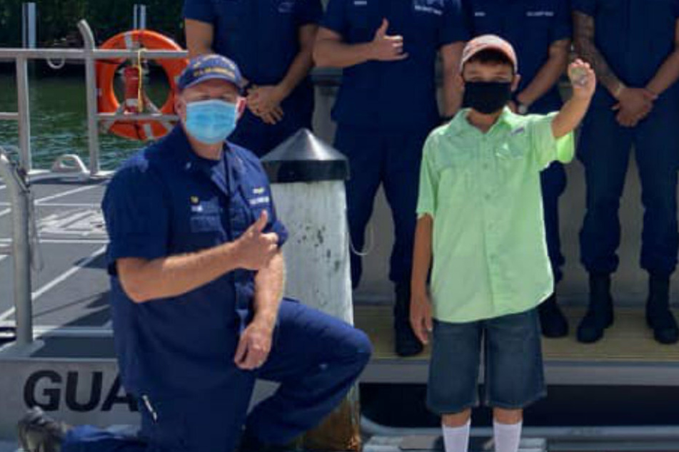 Avani Perez (11) proudly presents his gold coin, which he received from the coast guard for his courageous efforts.