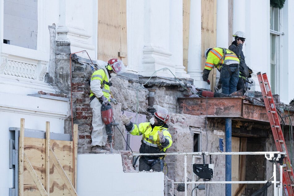 Construction workers demolish what is remaining of the East Wing of the White House in preparation to build a new ballroom on December 1, 2025.