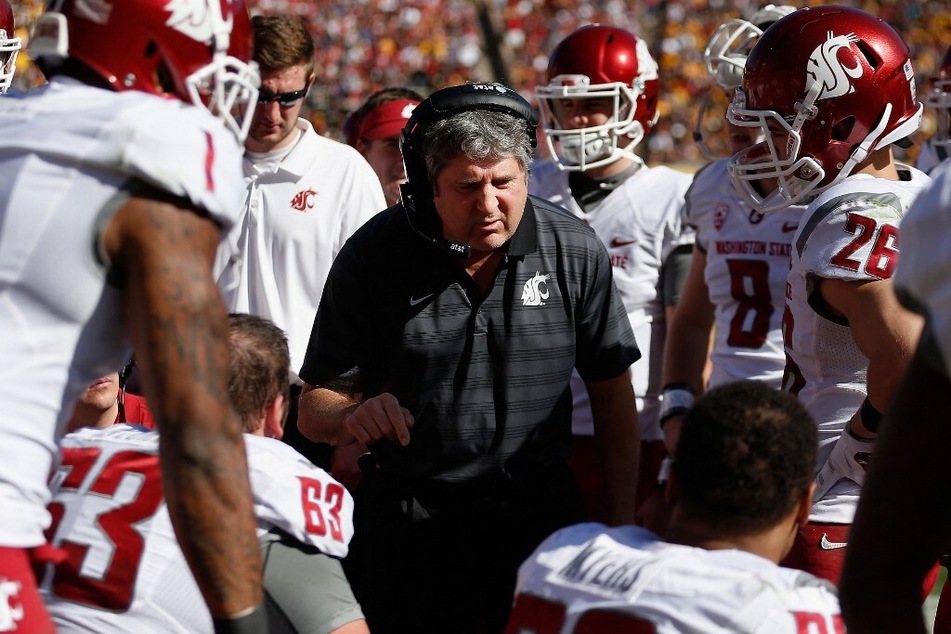 Several top college football coaches took to social media to express their condolences for Mike Leach (c) who passed away on Monday of heart related complications.