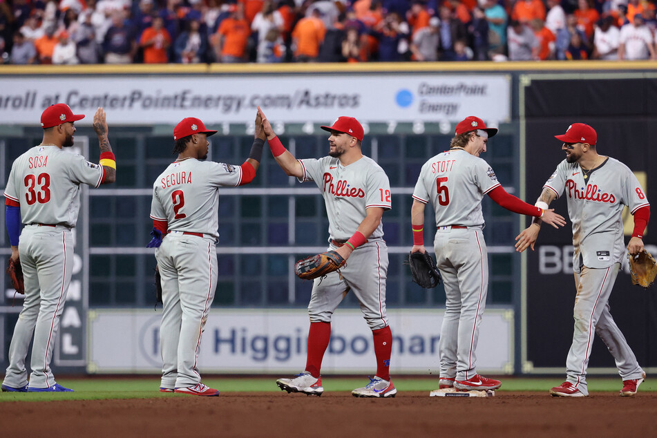 Philadelphia Phillies players celebrate after defeating the Houston Astros.