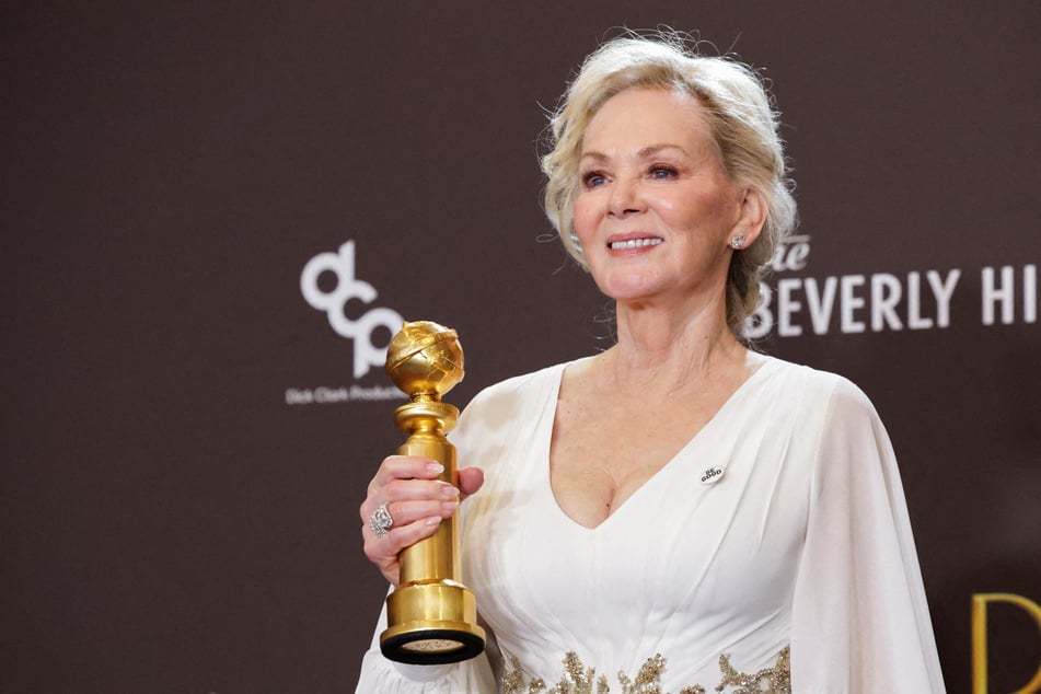 Jean Smart wears a BE GOOD pin as she poses with the Best Performance by a Female Actor in a Television Series during the 83rd Annual Golden Globes.