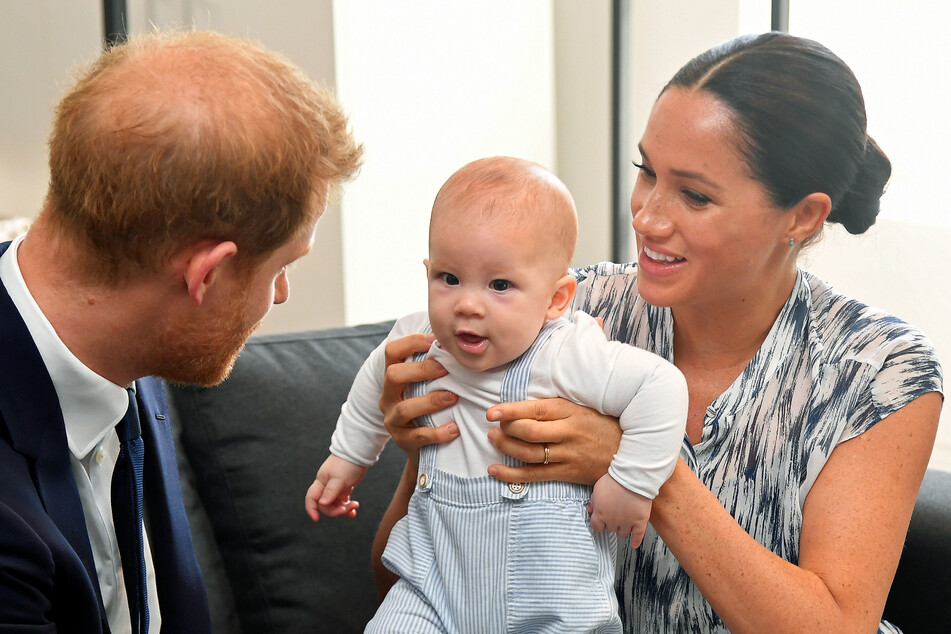Prince Harry with son Archie (2) and wife Megan (39).