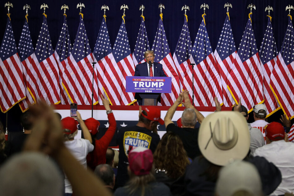 Trump mocked Biden's stuttering and continued his anti-migrant rhetoric in his speech at a campaign rally in Rome, Georgia.