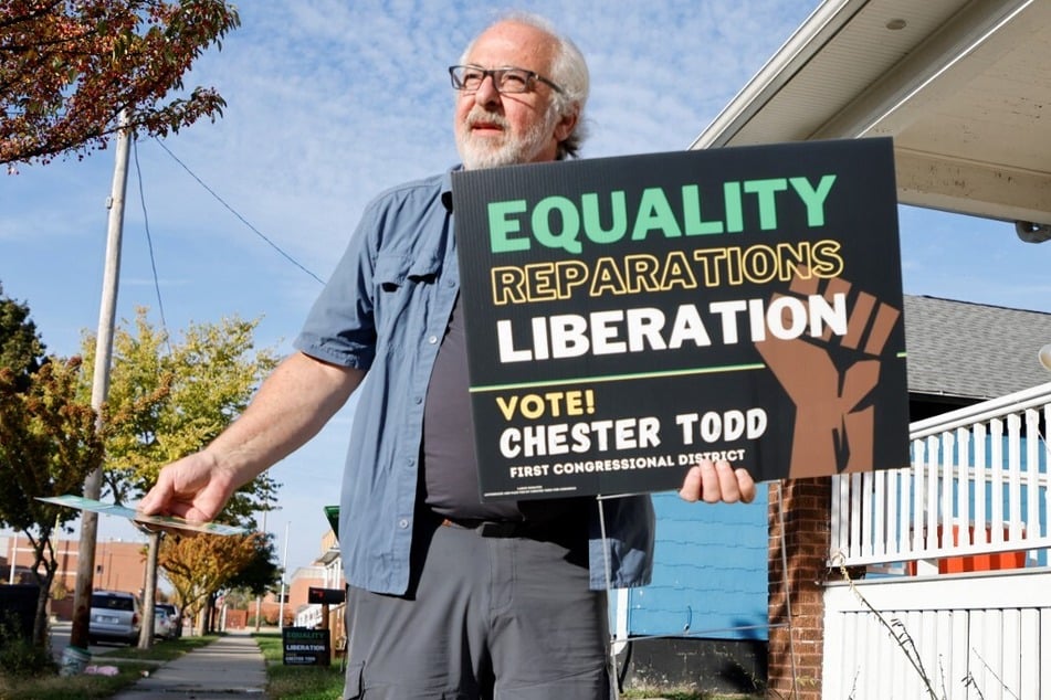 Green Party organizer Pete Karas works a neighborhood, placing signs in yards and handing out campaign literature, in Racine, Wisconsin.