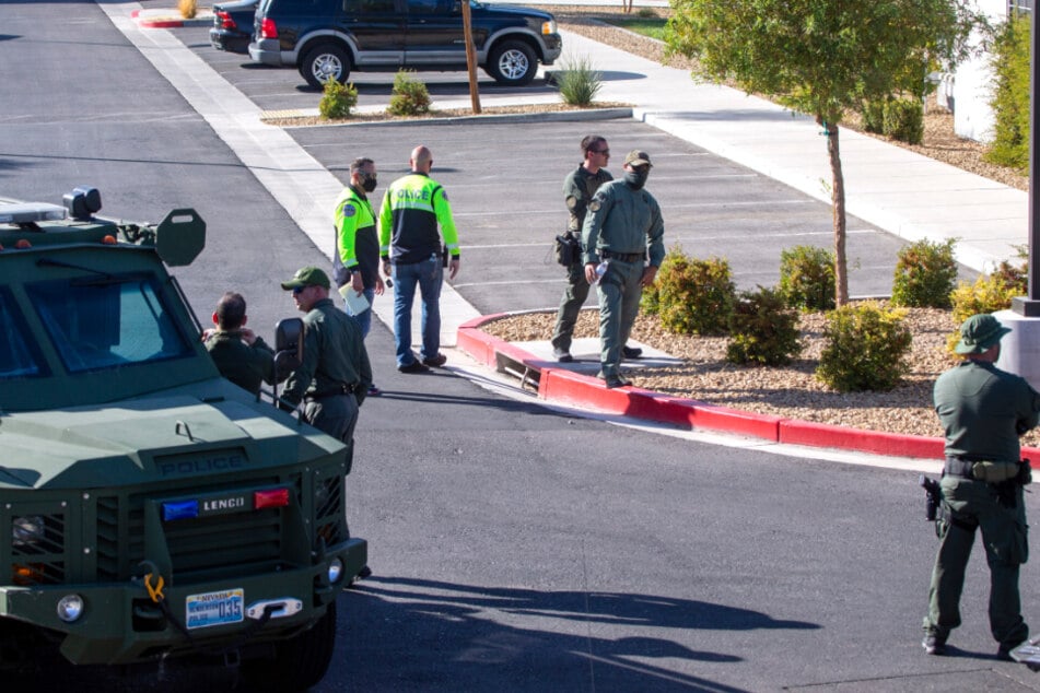 Police officers are investigating outside the apartment complex where the deadly shooting took place.