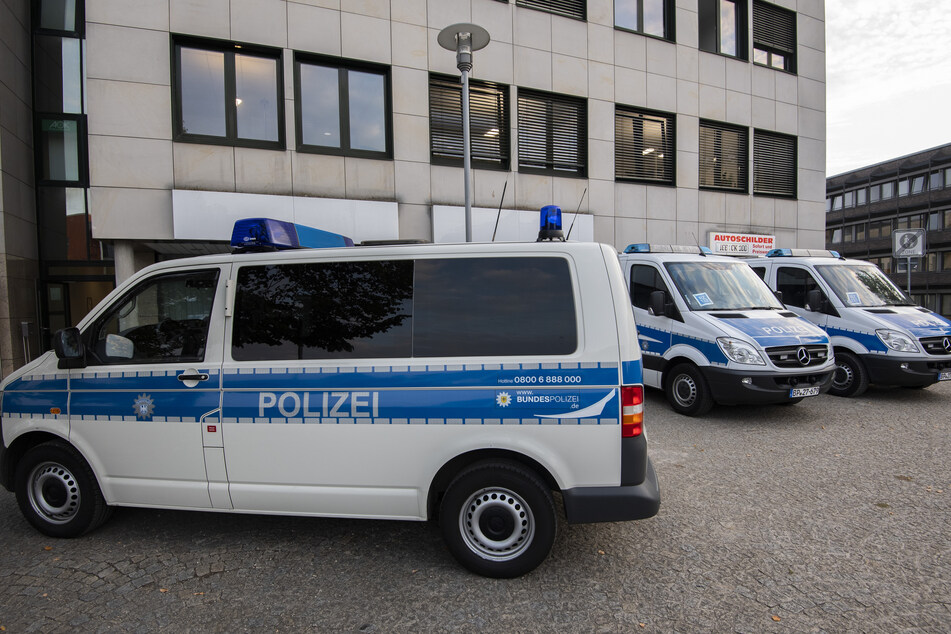 Fahrzeuge der Bundespolizei stehen bei einer bundesweiten Razzia vor einem Bürogebäude in der Region Hannover.