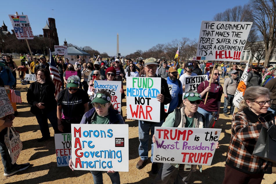 Protesters demonstrate against President Donald Trump during the "March 4 Democracy" rally on February 28, 2026 in Washington, DC.