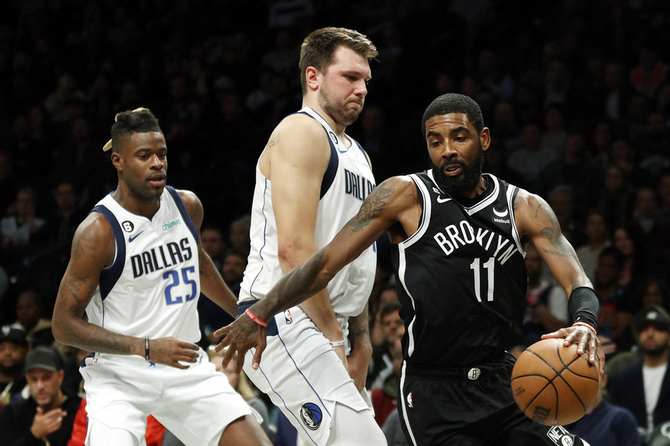 The Dallas Mavericks are said to have made a trade deal with the Brooklyn Nets for Kyrie Irving (r) and Markieff Morris.
