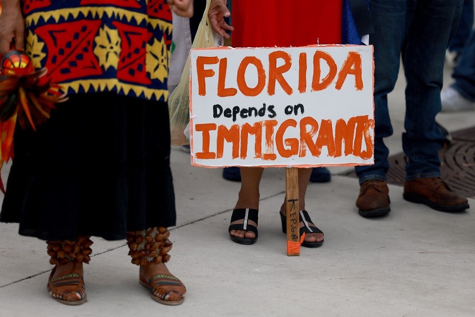 A sign reading "Florida Depends on Immigrants" is pictured at a demonstration against anti-immigrant legislation.