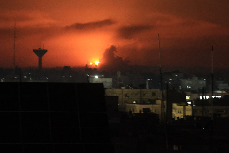 A picture taken from Rafah, on the southern Gaza Strip, shows smoke billowing over buildings following Israeli bombardment on December 4.
