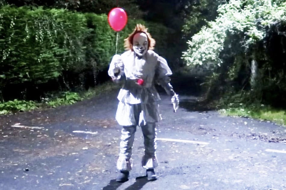 An unidentified person wearing a Pennywise-style costume has been intimidating locals of a small Scottish town and issuing concerning messages to the police via social media.