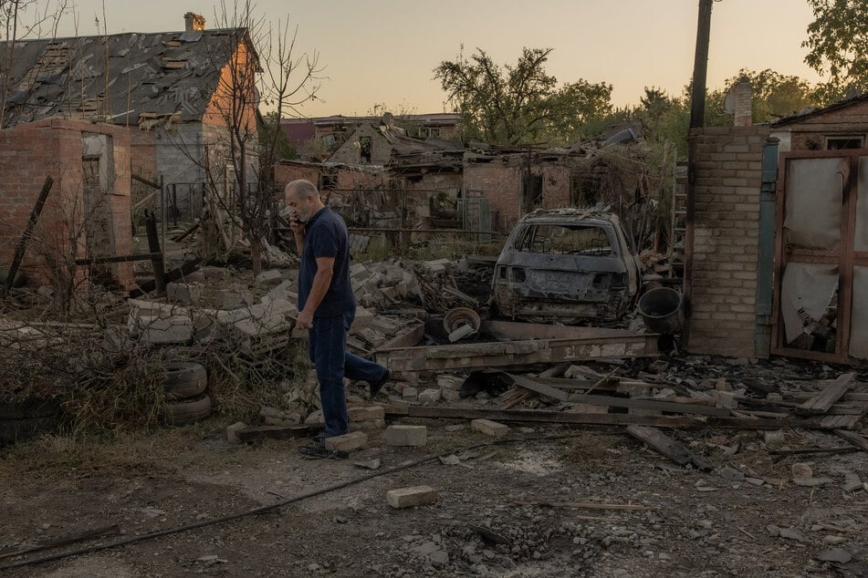 A local resident walks next to destroyed buildings following an air attack, in Kostyantynivka, eastern Donetsk region, on October 5, 2024, amid the Russian invasion of Ukraine.