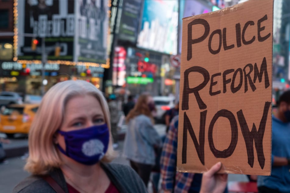 A protester holds a sign in favor of police reform during a rally in Times Square following the announcement of Derek Chauvin's guilty verdict on April 20.