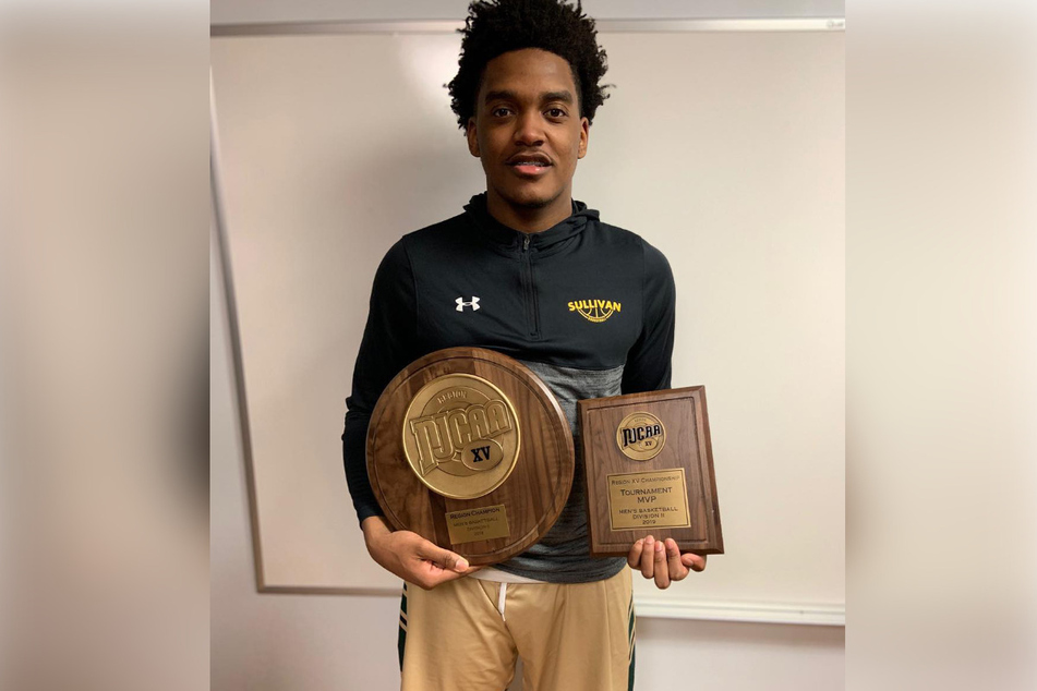 Darius Lee posing with his awards.