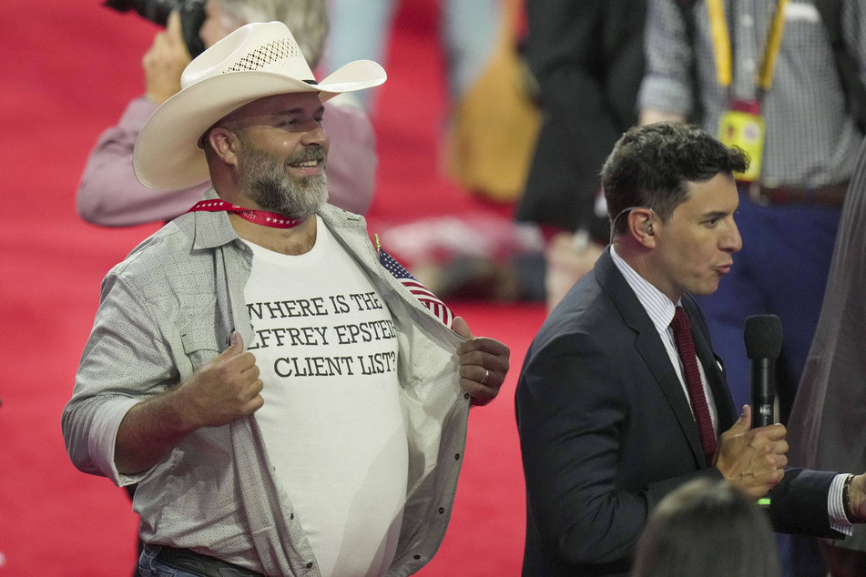 An attendee flashing a shirt that reads, "WHERE IS THE JEFFREY EPSTEIN CLIENT LIST?" during the second day of the Republican National Convention