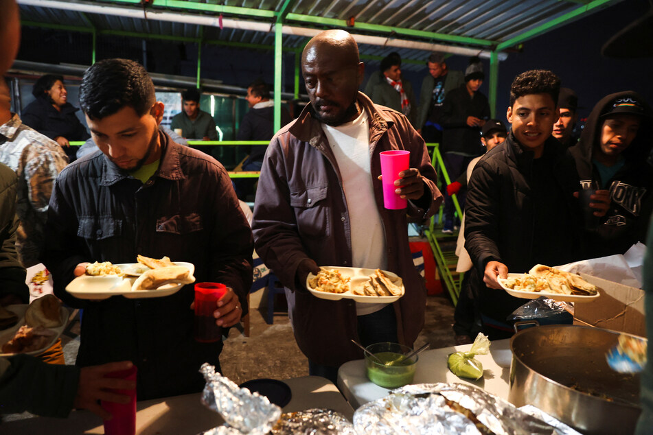 Migrants from Venezuela, Honduras, Nicaragua, Haiti, and Colombia serve themselves food as they spend Christmas at a shelter in Mexico City.