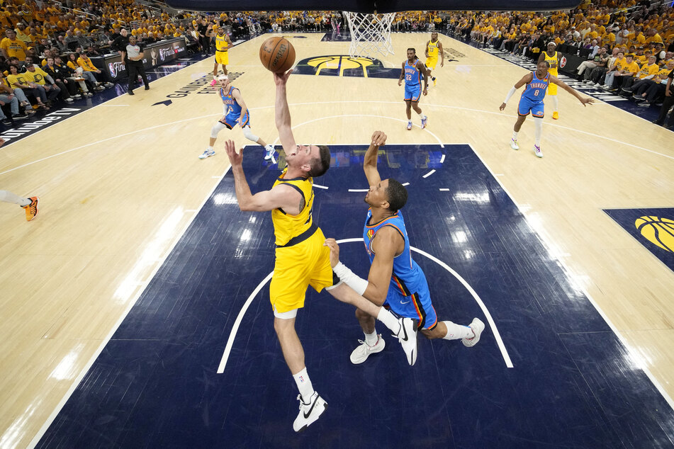 Indiana Pacers guard T.J. McConnell shoots the ball against Oklahoma City Thunder guard Aaron Wiggins during the first half during Game Three of the 2025 NBA Finals.