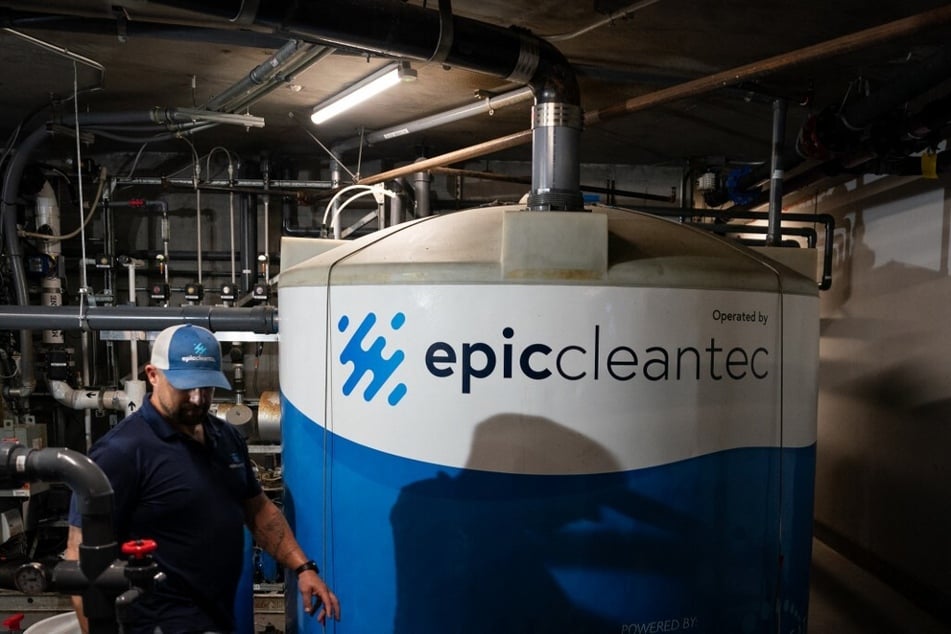 Ryan Pulley conducts system maintenance in the basement of a downtown building where Epic Cleantec’s technology is used.
