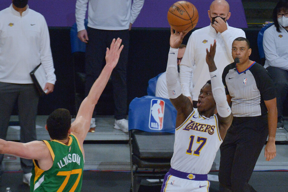 Lakers point guard Dennis Schroder scores over Jazz forward Ersan Ilyasova