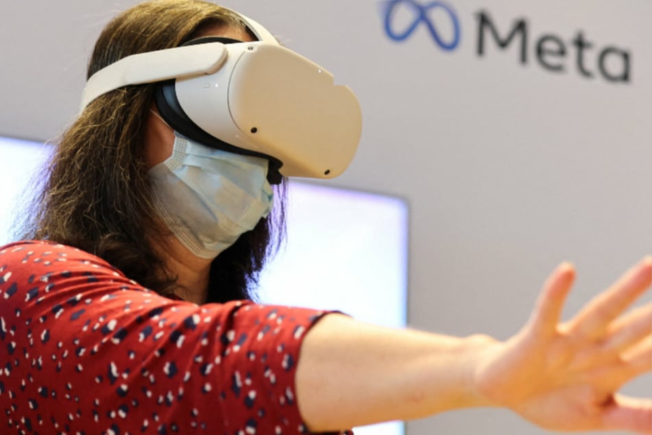 A person uses a virtual reality headset at Meta stand during the ninth Summit of the Americas in Los Angeles.