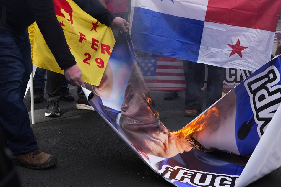 Pictures of Donald Trump were burned at a protest in front of the US embassy in Panama City after the president-elect's threat to take control of the Panama Canal.