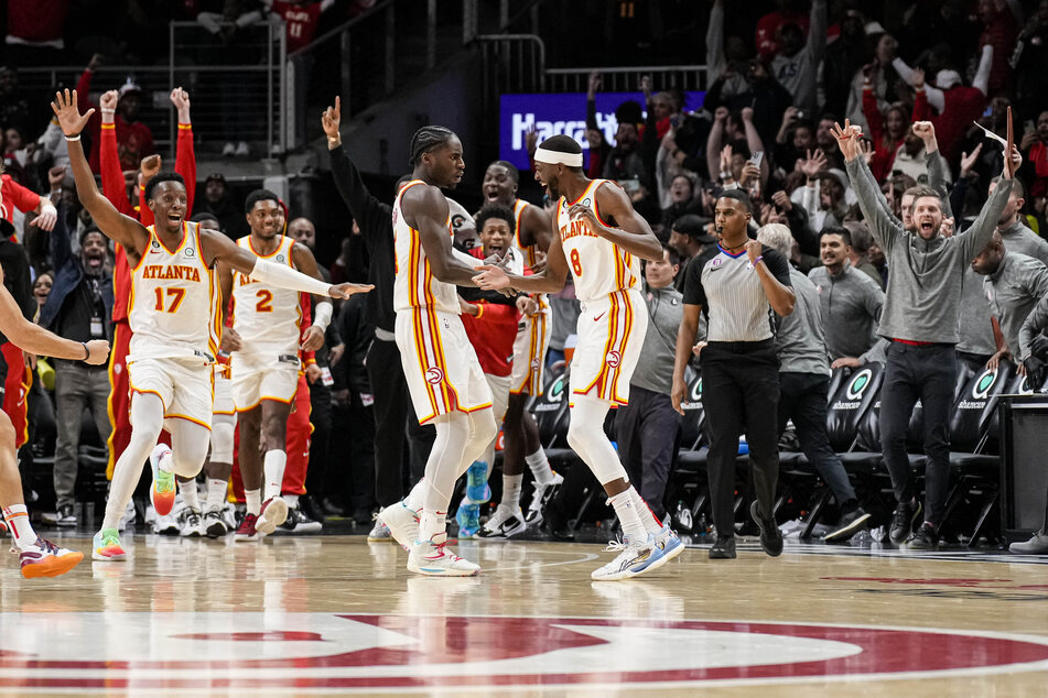 The Hawks' AJ Griffin (2nd from r.) celebrates his buzzer-beater against the Phoenix Suns.
